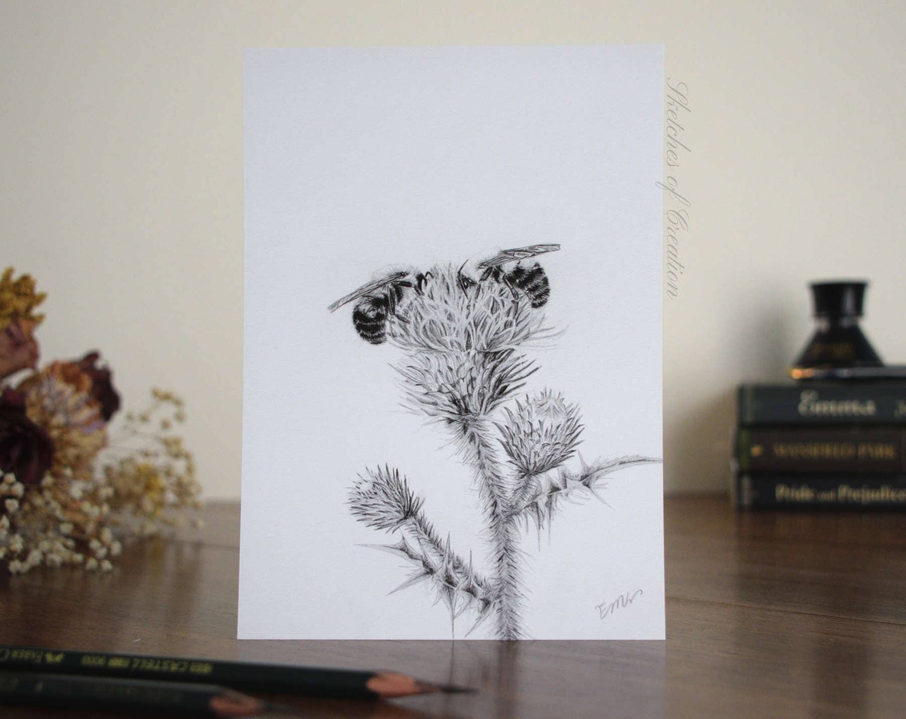 A print of two bees on a thistle flower